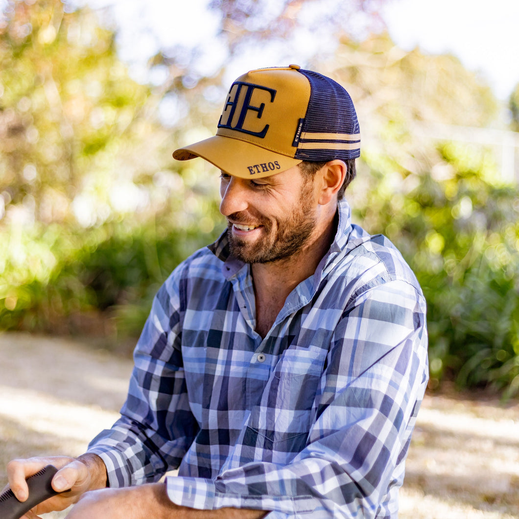 This image features the Ethos Trucker Hat in Khaki.